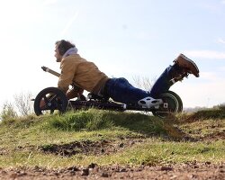 maximum thrill: swerv's electric trike lets riders skim the pavement face-first