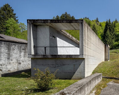 three cemeteries emerge between stone walls and mountain horizons in the carnic alps