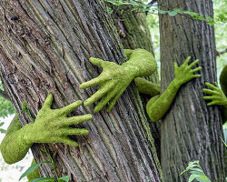 have you ever hugged a tree? monsieur plant wraps sculptural human arms around trees