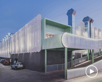 OOIIO wraps reused madrid auto center in permeable skin of vertical metal slats