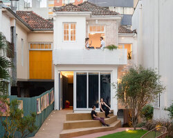 exposed brick and blue metal transform a 1930s brazilian house into a cultural art hub