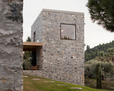 three monolithic volumes by not a number architects reinterpret greek stone house typology