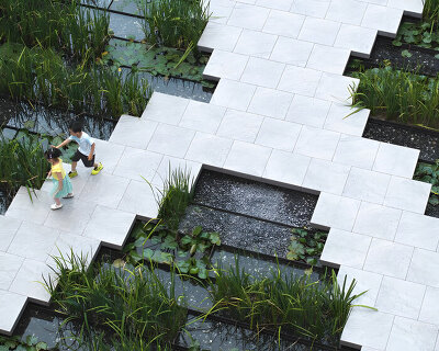 a garden-within-a-garden unfolds through water, translucent pavilions, and green courtyards