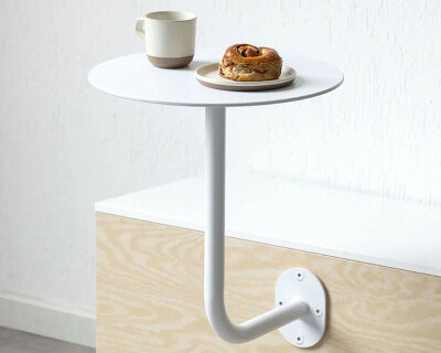 an aluminum café table that lifts away from the wall redefines flexible hospitality furniture