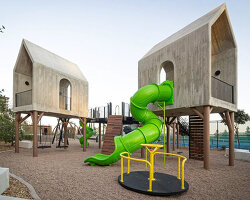 house-like concrete play structures frame community arc park in chihuahua