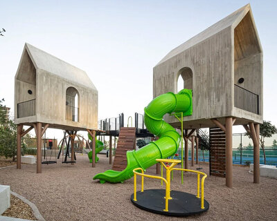 house-like concrete play structures frame community arc park in chihuahua
