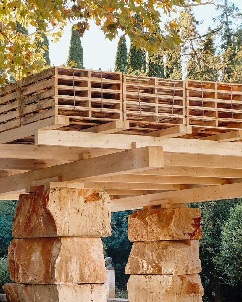 aulets stacks natural stone beneath a recycled pallet roof in mallorca - 1