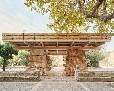aulets stacks natural stone beneath a recycled pallet roof in mallorca