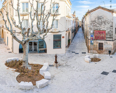 carved travertine transforms paving, furniture, and planting across spanish historic old town
