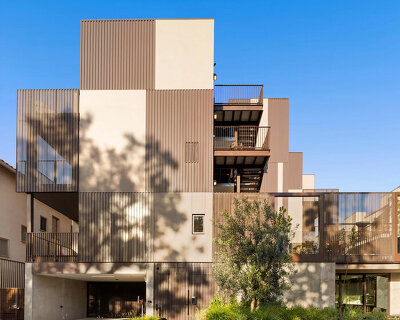 bronze corrugated metal wraps spf:architects' multifamily housing in west hollywood