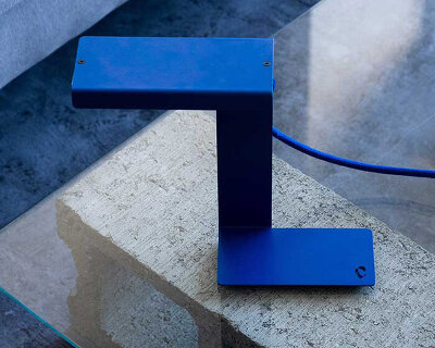 single sheet of folded steel sculpts into z-shaped table lamp