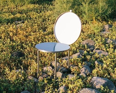 deliberately uncomfortable stainless steel chair turns sitting into social commentary