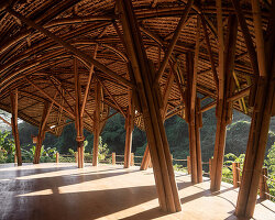 lotus-shaped bamboo roof floats over pablo luna studio's yoga space in bali