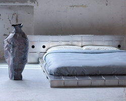 aluminum and bolted steel turn platform bed into architectural piece at paris design week
