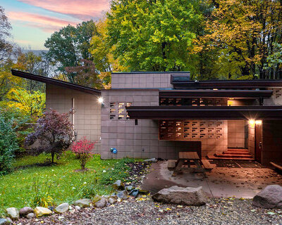 cantilevered roof extends over frank lloyd wright’s concrete usonian house, now listed
