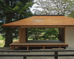 leaning timber frame anchors shrine office in japanese mountain valley