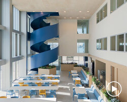 blue spiral staircase anchors ERRE’s harbor-side workspace in valencia