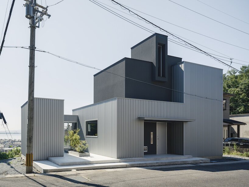 glazed passage frames lake views through this compact japanese house - 1