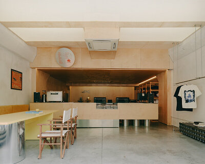 plywood and reflective steel build retro-futurist print shop in tbilisi’s former factory