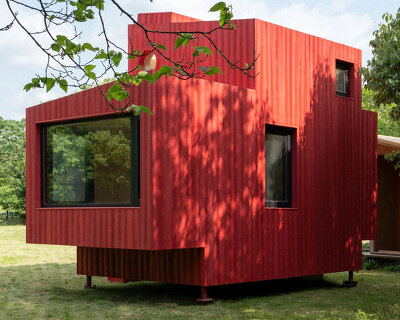 compact forest cabin by wiki world takes shape as a red wooden submarine