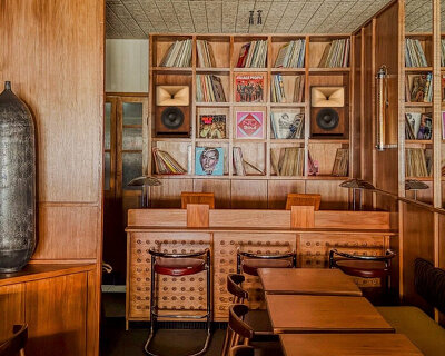 SOBO wraps paris listening restaurant in oak, vintage furniture, and acoustic panels