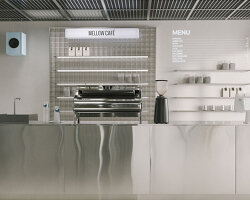suspended metal grid ceiling meets translucent and reflective surfaces inside french café