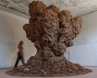 bomb cloud sculpture takes shape in soil, straw and water inside abandoned lisbon school