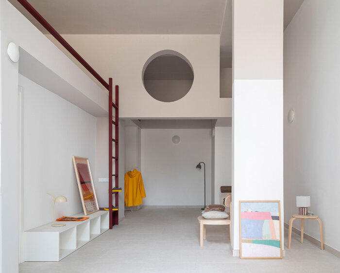 garnet-red accents and high clerestories punctuate AA Apartments in málaga
