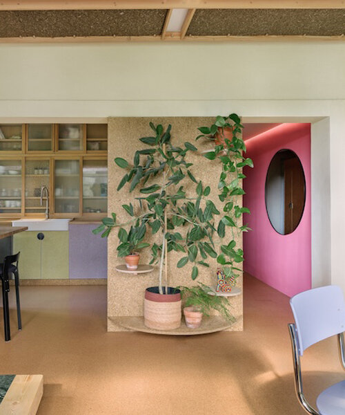 stepped timber platforms and operable textiles shape circular düsseldorf home by urselmann interior