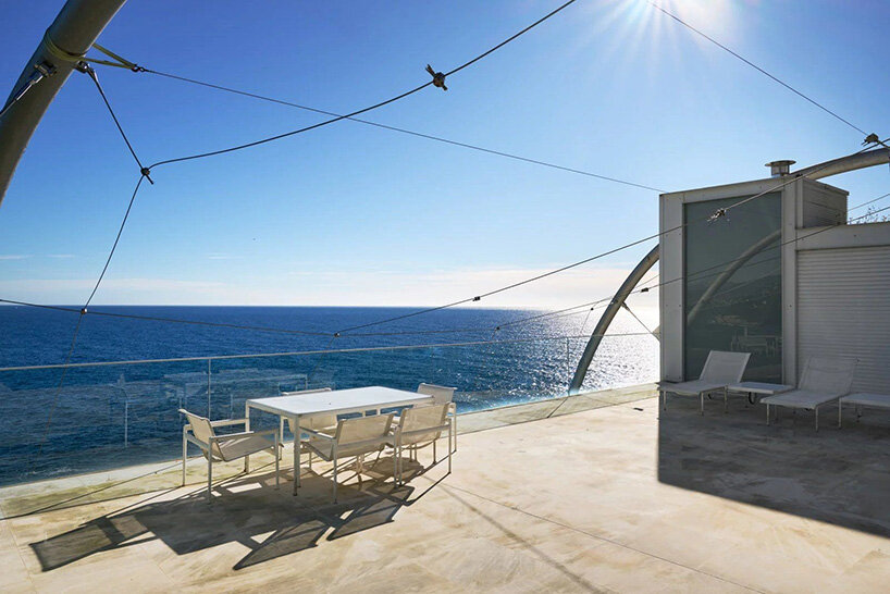terrace overlooking the Mediterranean with steel cables and sail-like canopy supports