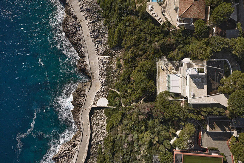 Aerial view of the villa, surrounding gardens, and Mediterranean coastline