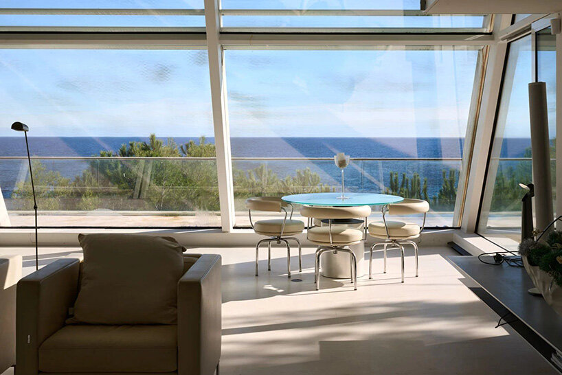 living area with floor-to-ceiling windows overlooking the sea
