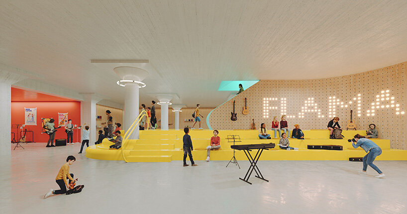 students sit on a yellow stepped platform beneath illuminated FLAMA lettering in a shared music and performance space