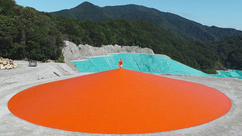 ryue nishizawa places vivid orange peak against turquoise landfill in japan - 3