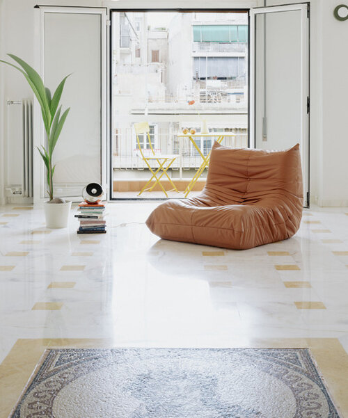 bacchus floor mosaic inspires yellow terrazzo and marble apartment renovation in athens