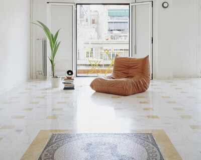 bacchus floor mosaic inspires yellow terrazzo and marble apartment renovation in athens