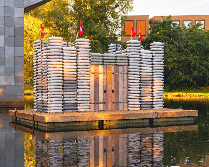 sandbag castle casts sustainable concrete alternatives into floating installation in eindhoven